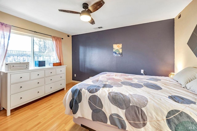 bedroom with ceiling fan and light hardwood / wood-style floors