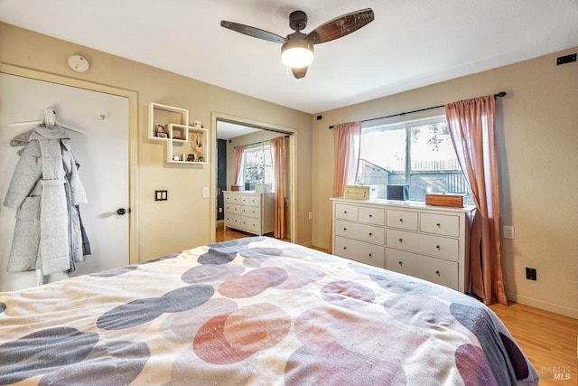 bedroom with a closet, ceiling fan, and light hardwood / wood-style flooring