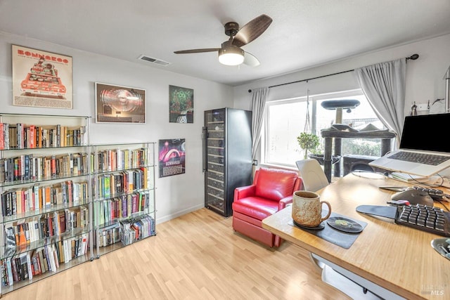 office space featuring light hardwood / wood-style floors and ceiling fan