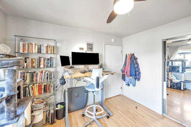 home office featuring hardwood / wood-style floors and ceiling fan