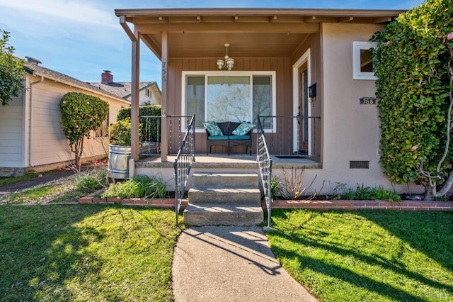 property entrance with a lawn and a porch