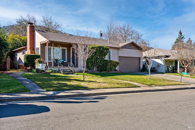 ranch-style home with a garage, a front yard, and covered porch