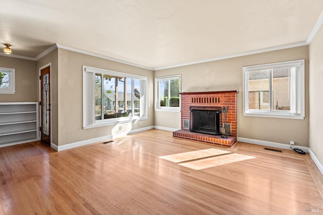 unfurnished living room featuring crown molding, a fireplace, and light hardwood / wood-style floors