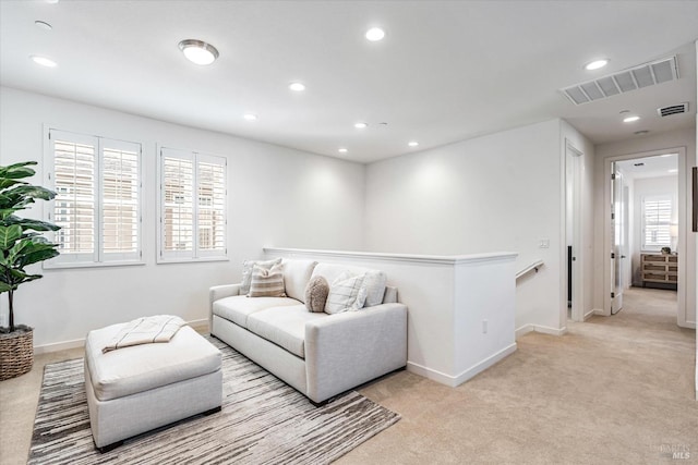 living room with light carpet, baseboards, visible vents, and recessed lighting