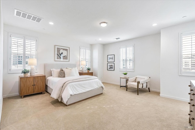 bedroom with light carpet, recessed lighting, visible vents, and baseboards