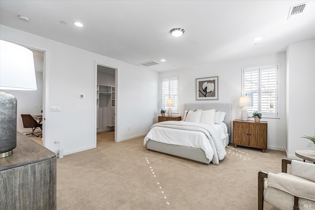 bedroom with light carpet, visible vents, and multiple windows