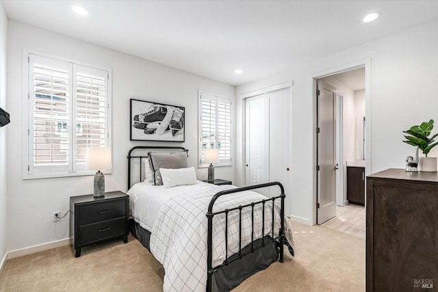 bedroom with light carpet, a closet, and recessed lighting