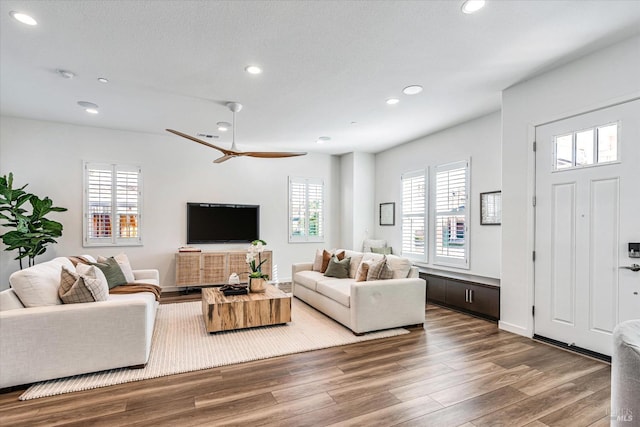 living room with dark wood-style floors, recessed lighting, a textured ceiling, and a ceiling fan