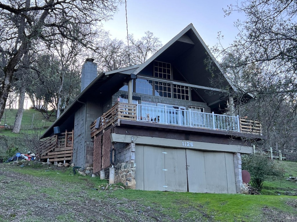 back of house with a lawn