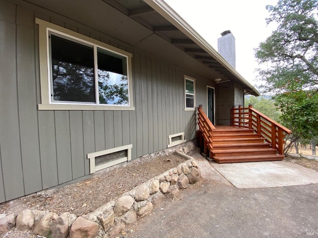 entrance to property with crawl space and a chimney