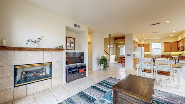 living room featuring a fireplace and light tile patterned flooring