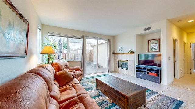 tiled living room with a tiled fireplace