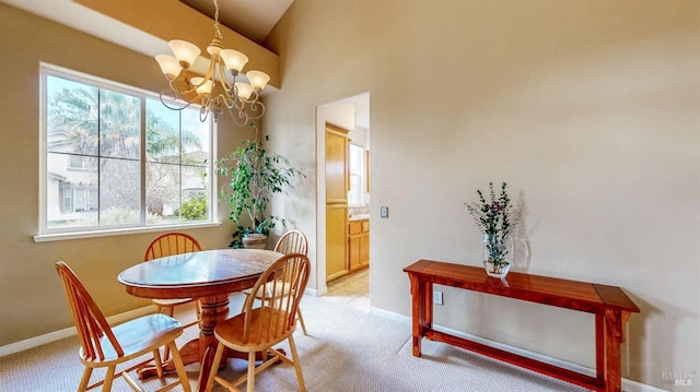 dining space featuring light carpet, a notable chandelier, and lofted ceiling