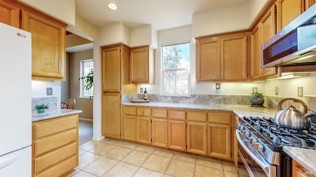 kitchen with appliances with stainless steel finishes and light tile patterned floors