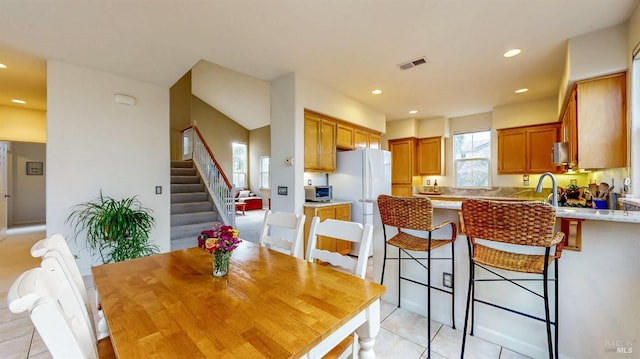 tiled dining room featuring sink