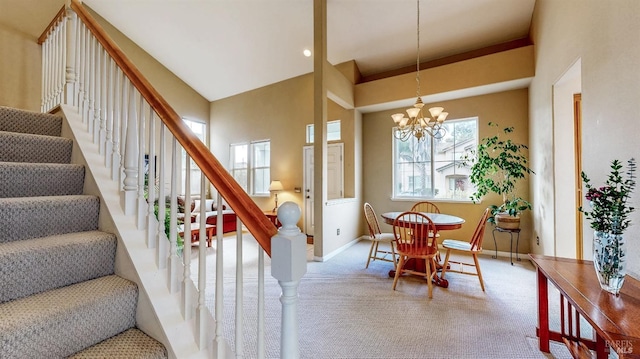 dining room with a notable chandelier, a high ceiling, and carpet flooring