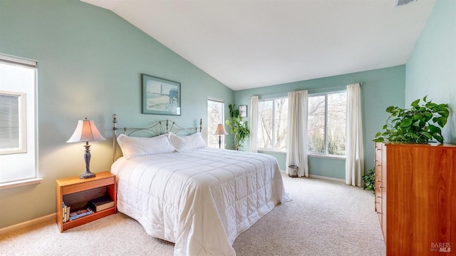 bedroom featuring lofted ceiling and light colored carpet