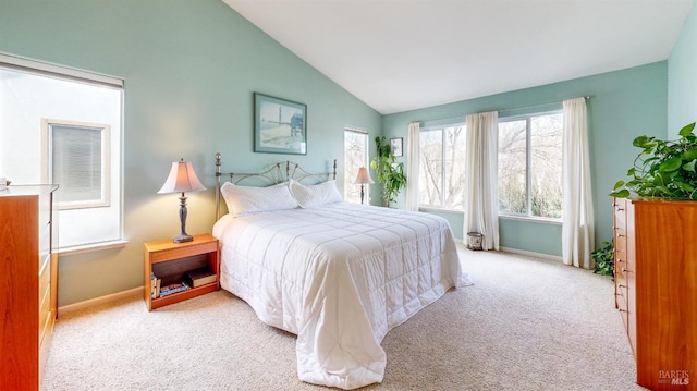 bedroom with high vaulted ceiling and light carpet