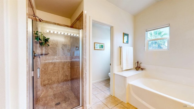 bathroom with tile patterned flooring, toilet, and separate shower and tub