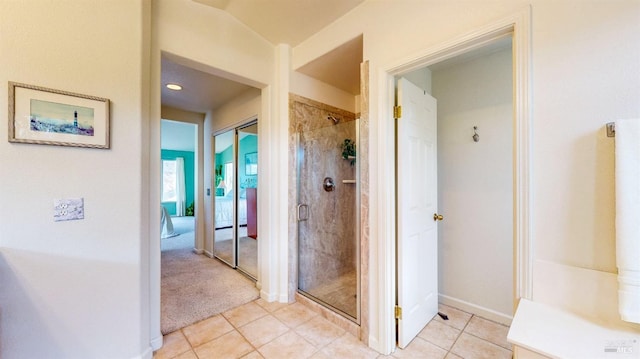 bathroom featuring tile patterned flooring and an enclosed shower