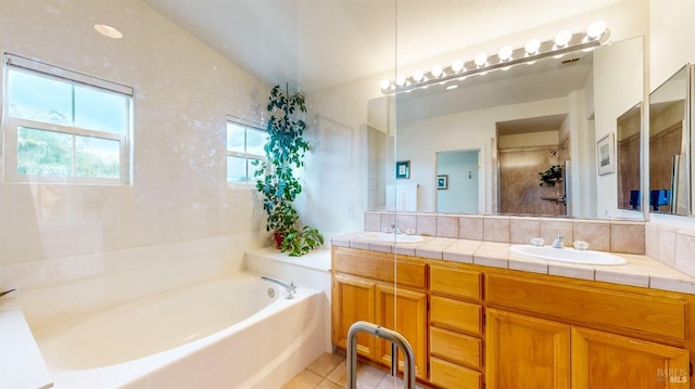 bathroom with vanity, a bathtub, and tile patterned floors