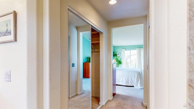 hallway with light colored carpet