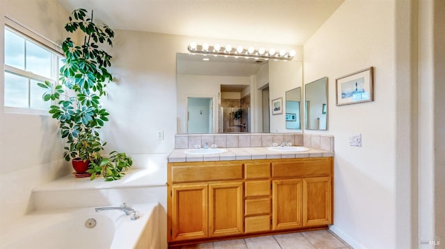 bathroom with tile patterned flooring, vanity, and separate shower and tub