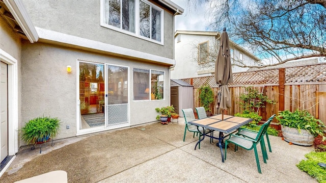 view of patio featuring a storage unit