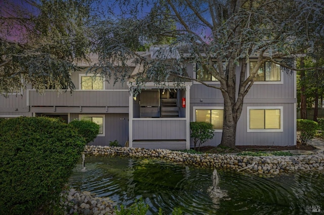 rear view of property featuring a water view