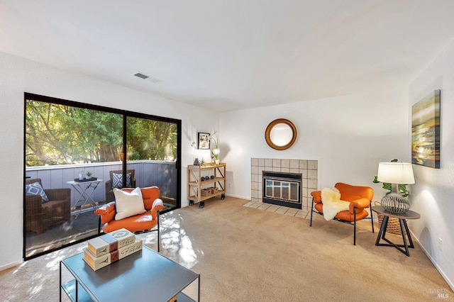 living room with light carpet and a fireplace