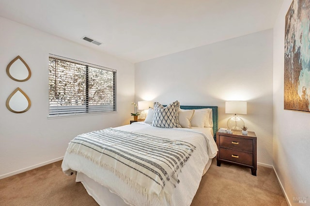 bedroom with light colored carpet