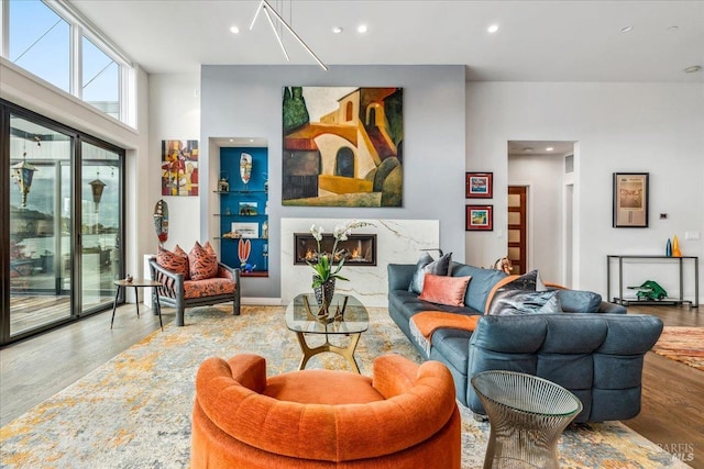 living room with a fireplace, wood finished floors, and recessed lighting