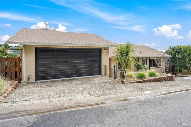 single story home featuring roof with shingles, driveway, and stucco siding