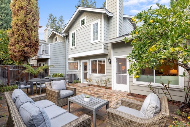 back of property featuring an outdoor living space, a patio, and central air condition unit