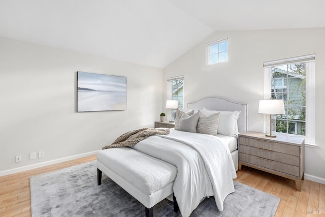 bedroom featuring hardwood / wood-style floors and vaulted ceiling