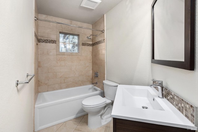 full bathroom featuring tiled shower / bath, vanity, and toilet