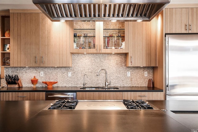 kitchen featuring tasteful backsplash, appliances with stainless steel finishes, sink, and wall chimney range hood