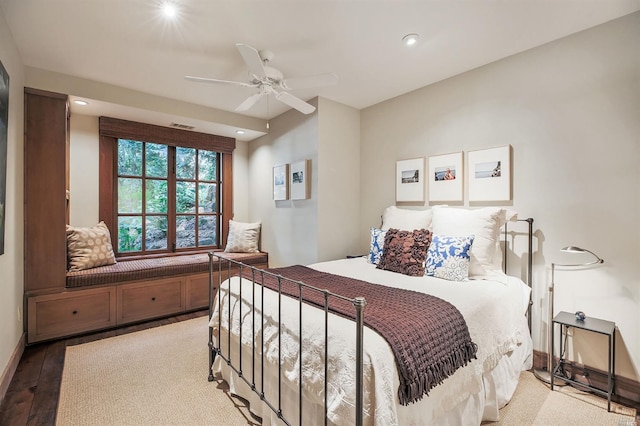 bedroom with hardwood / wood-style floors and ceiling fan