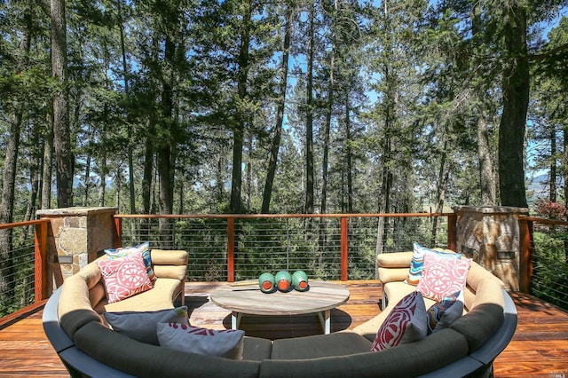 wooden terrace with an outdoor living space