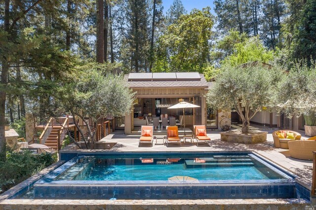 view of swimming pool with an in ground hot tub, an outdoor hangout area, and a patio