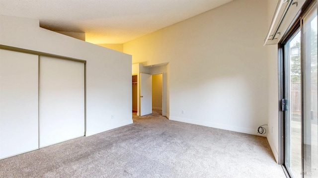 unfurnished bedroom featuring light colored carpet and a closet