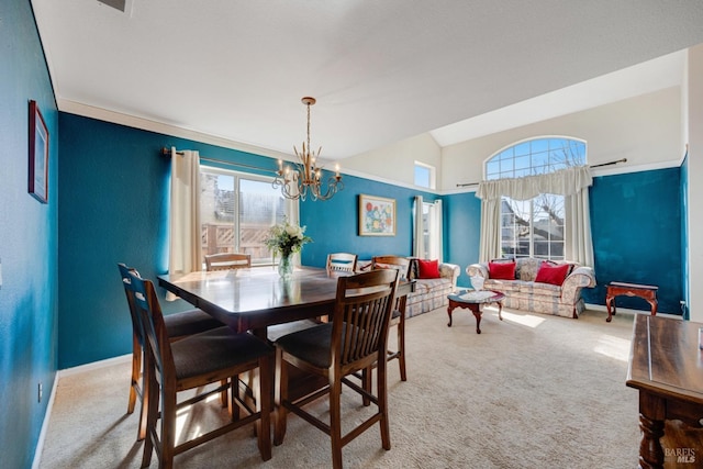 dining area with carpet floors, baseboards, vaulted ceiling, and a notable chandelier