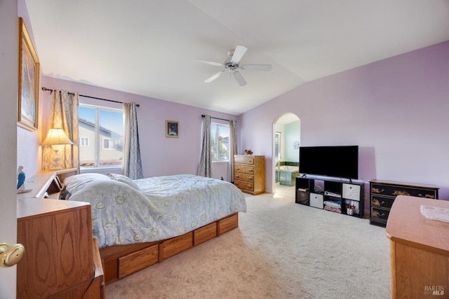 carpeted bedroom featuring a ceiling fan, arched walkways, and vaulted ceiling