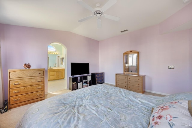 carpeted bedroom with arched walkways, ceiling fan, lofted ceiling, visible vents, and baseboards