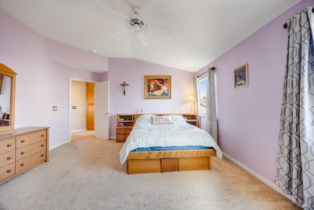 bedroom featuring a ceiling fan, lofted ceiling, light colored carpet, and baseboards