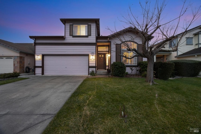 view of front of home featuring driveway, a lawn, and an attached garage