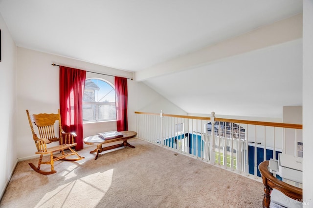 sitting room featuring lofted ceiling with beams and carpet flooring