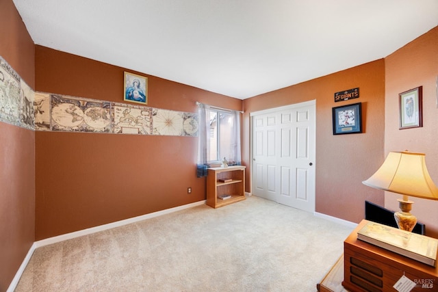 interior space with carpet, a closet, and baseboards