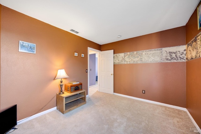 interior space with carpet flooring, visible vents, and baseboards