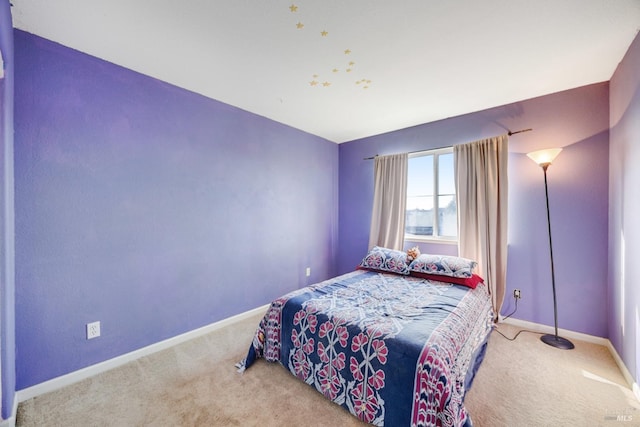 bedroom with baseboards and carpet flooring